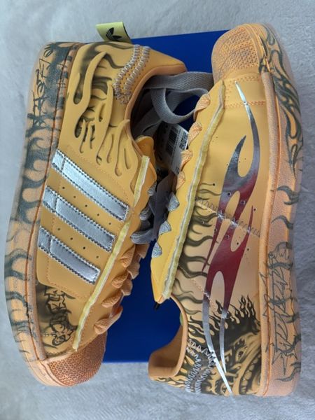 One of the six photos in the album: a pair of orange Adidas Hellstar Superstar sneakers with flame graphics and silver stripes